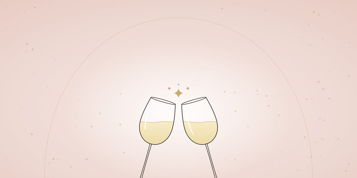 Two glasses of white wine raised in a toast on a soft blush background